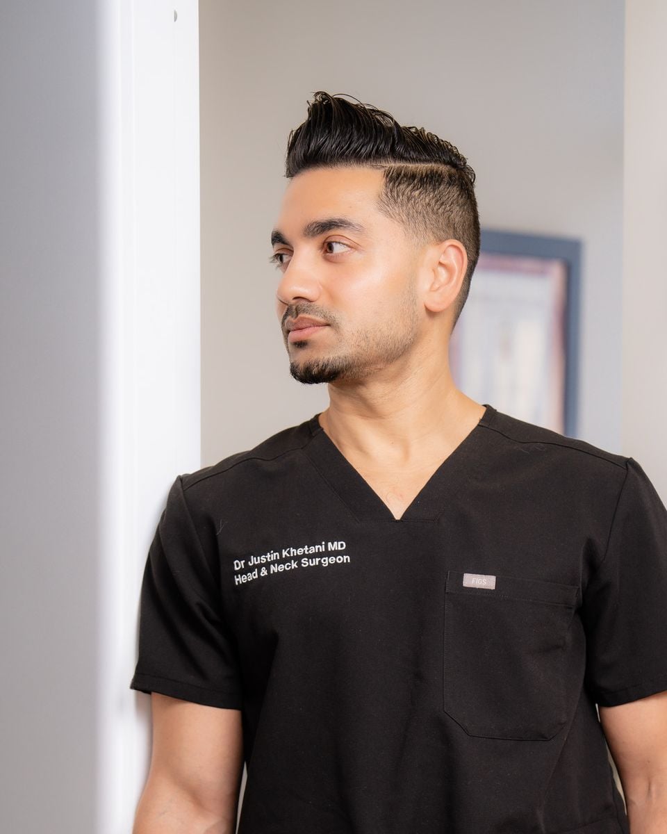 Dr. Justin Khetani, otolaryngologist and head and neck surgeon, in a corridor of the Burlington clinic