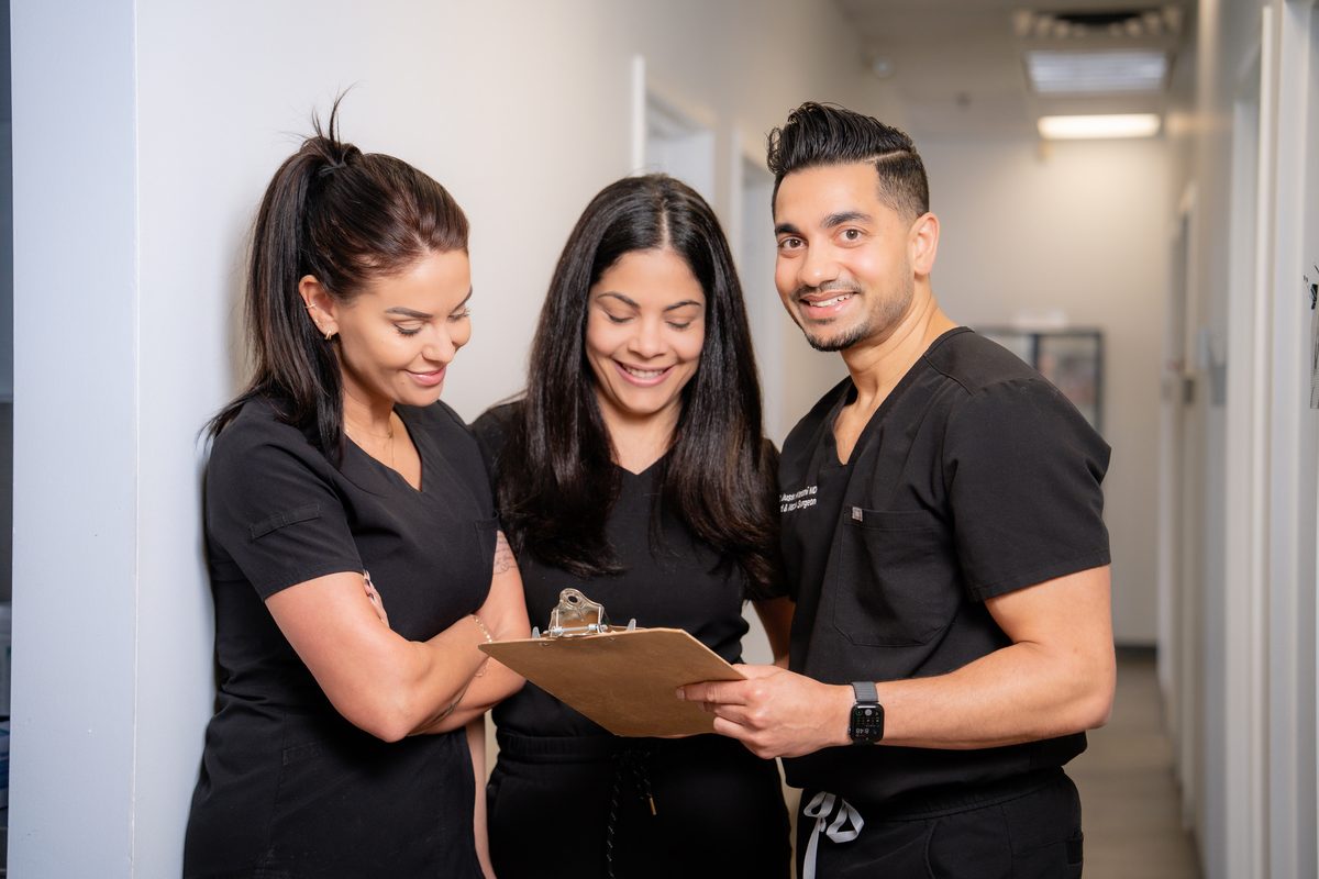 Dr. Justin Khetani reviewing a chart with two clinic team members in the Burlington office