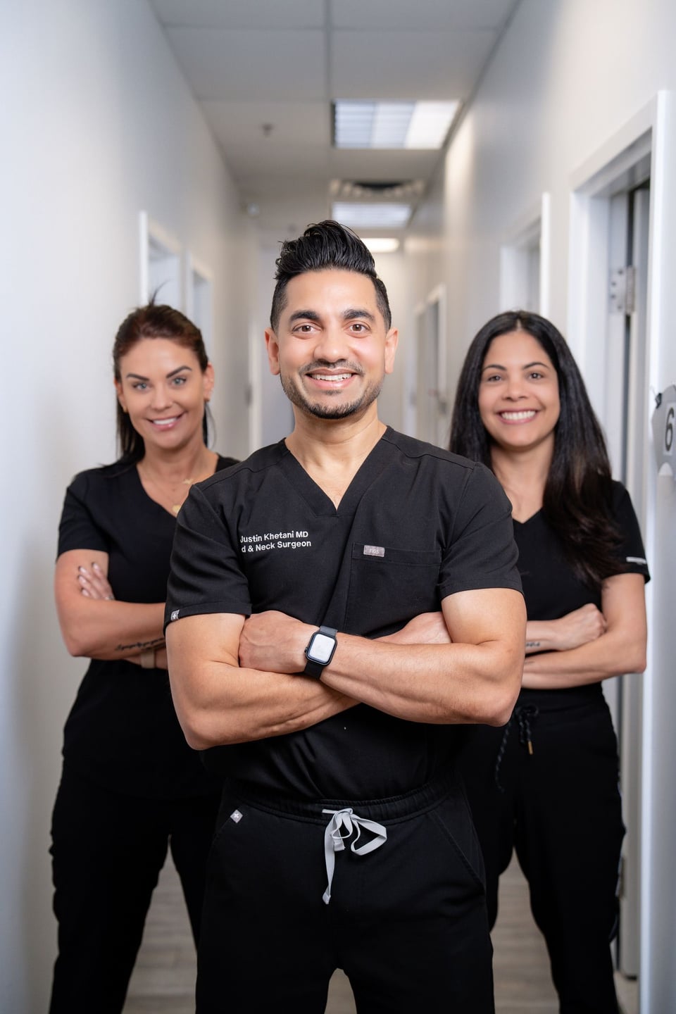 Dr. Justin Khetani with the two members of the clinic team in a hallway of the Burlington clinic